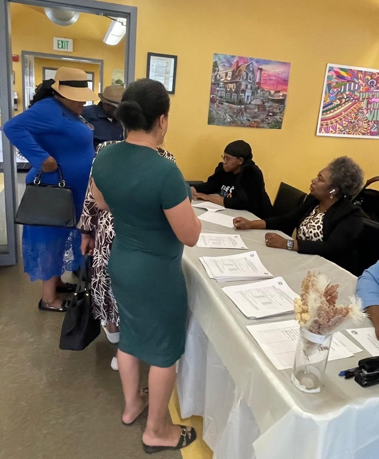 Participants registering at a R.I.S.E. program intake table